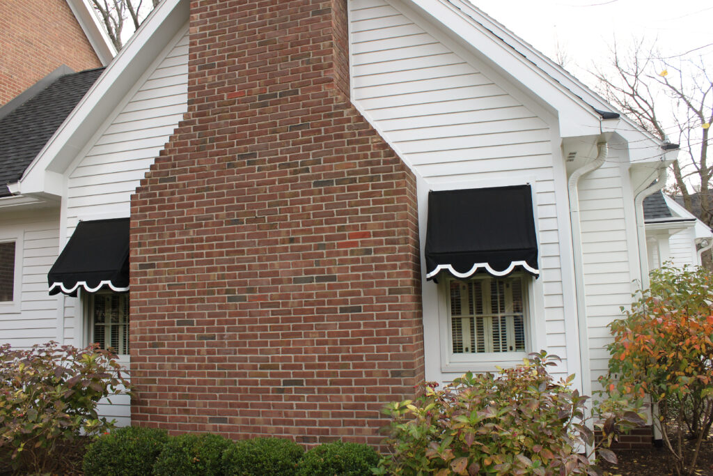 Black residential window awning Anchor Industries installation