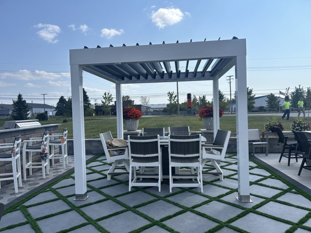 Modern white pergola with outdoor dining setup on a tiled patio.