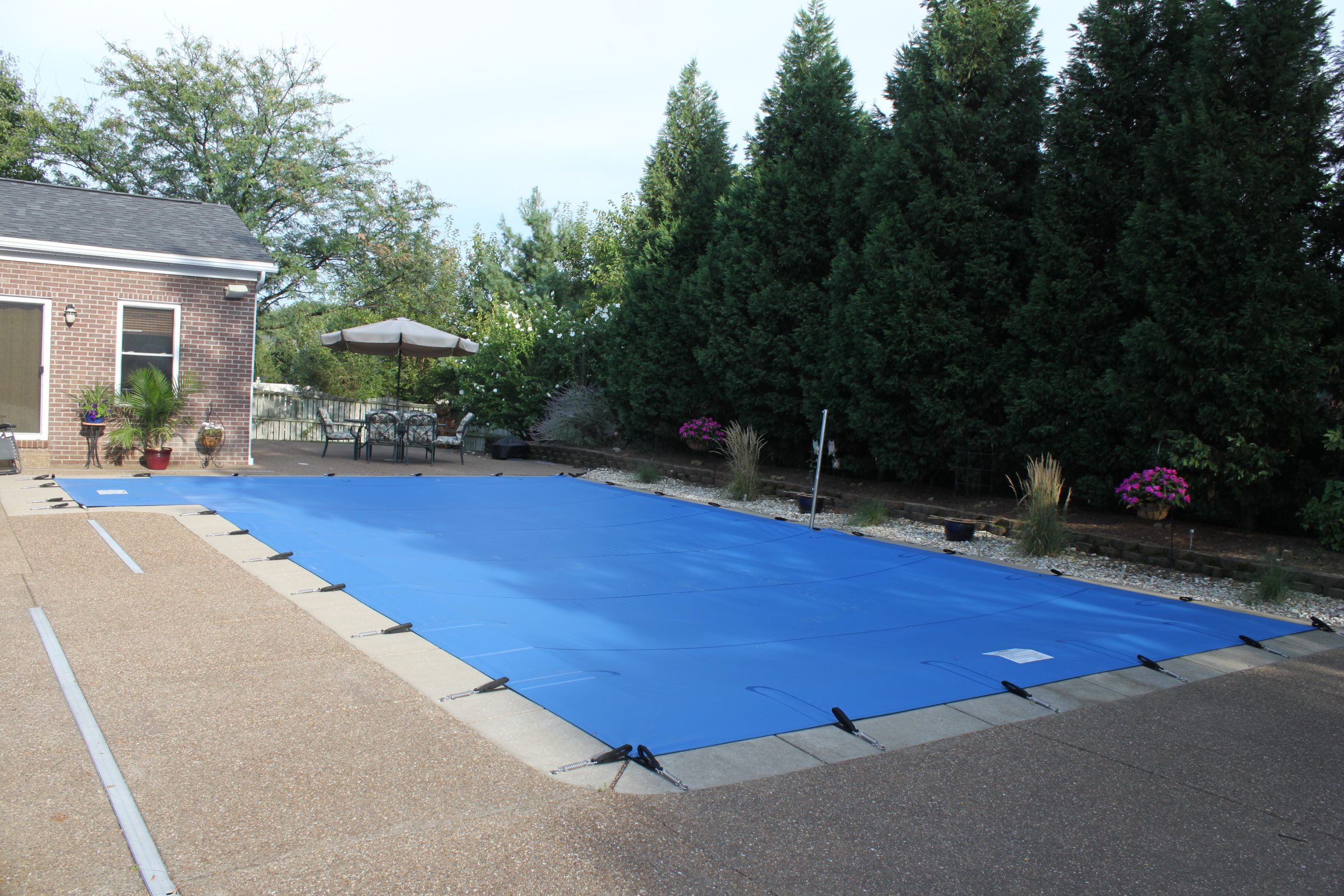 Blue safety pool cover Anchor Industries residential installation