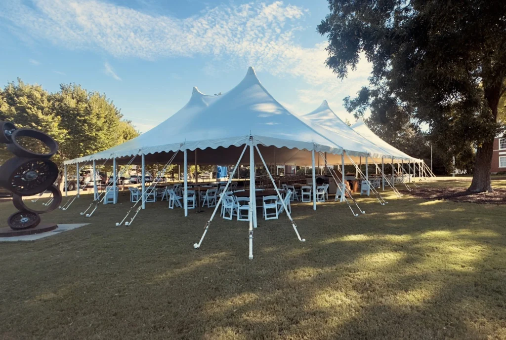 Round event tent with white canopy and open sides for outdoor party