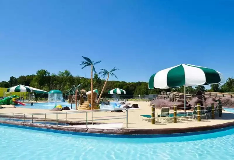 Large green and white pool shade umbrella Anchor Industries resort