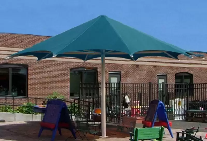 Green umbrella shade structure at community pool Anchor Industries
