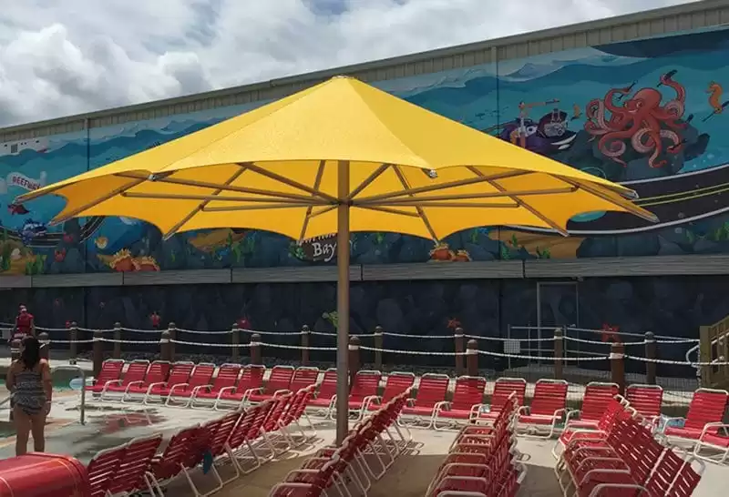 Anchor Industries yellow shade umbrella at resort pool