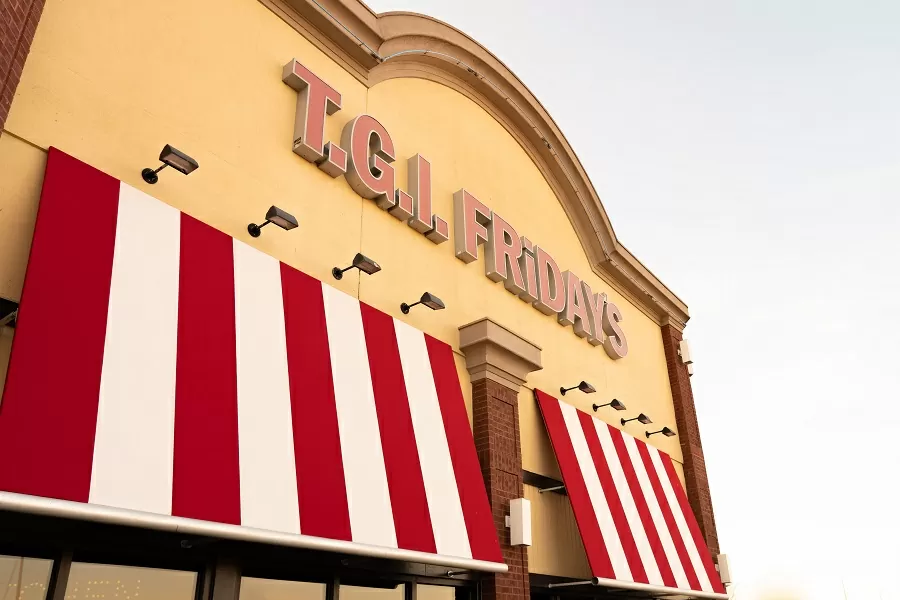 Red and white striped awning on the front of a TGI Fridays building.
