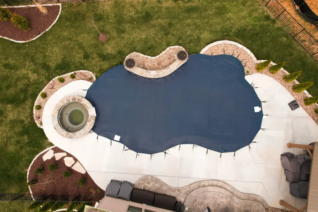 Aerial view of custom dark blue pool safety cover.
