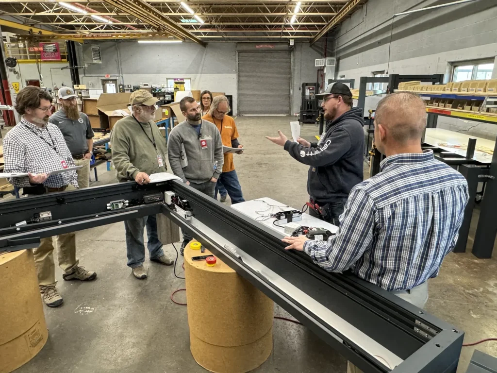 Training session with technicians handling pergola assembly.