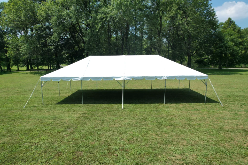 Outdoor frame party tent set up on grass field with open sides