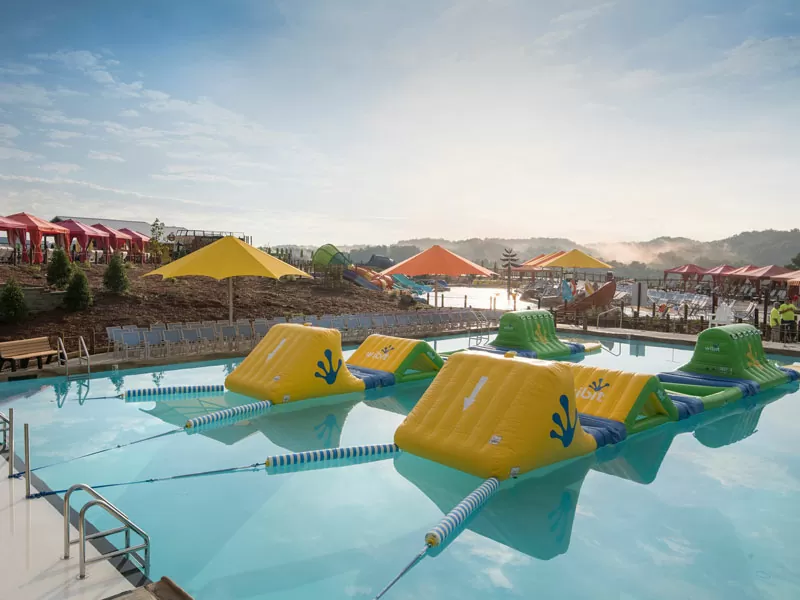 Floating yellow pool shade umbrellas by Anchor Industries