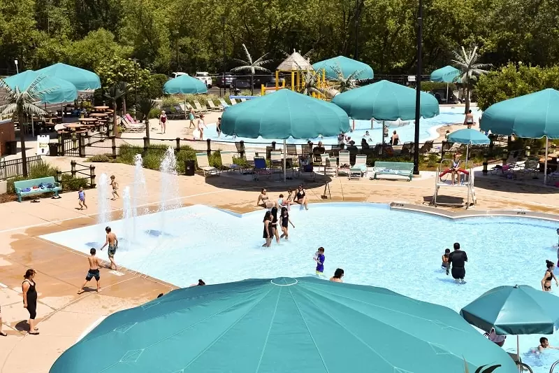 Anchor Industries teal shade umbrellas at community swimming pool