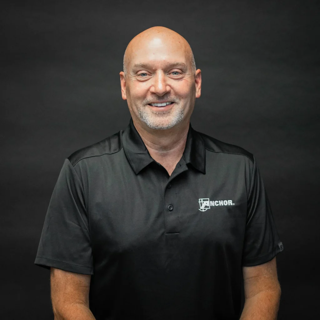 Portrait of Anchor Industries employee in branded shirt