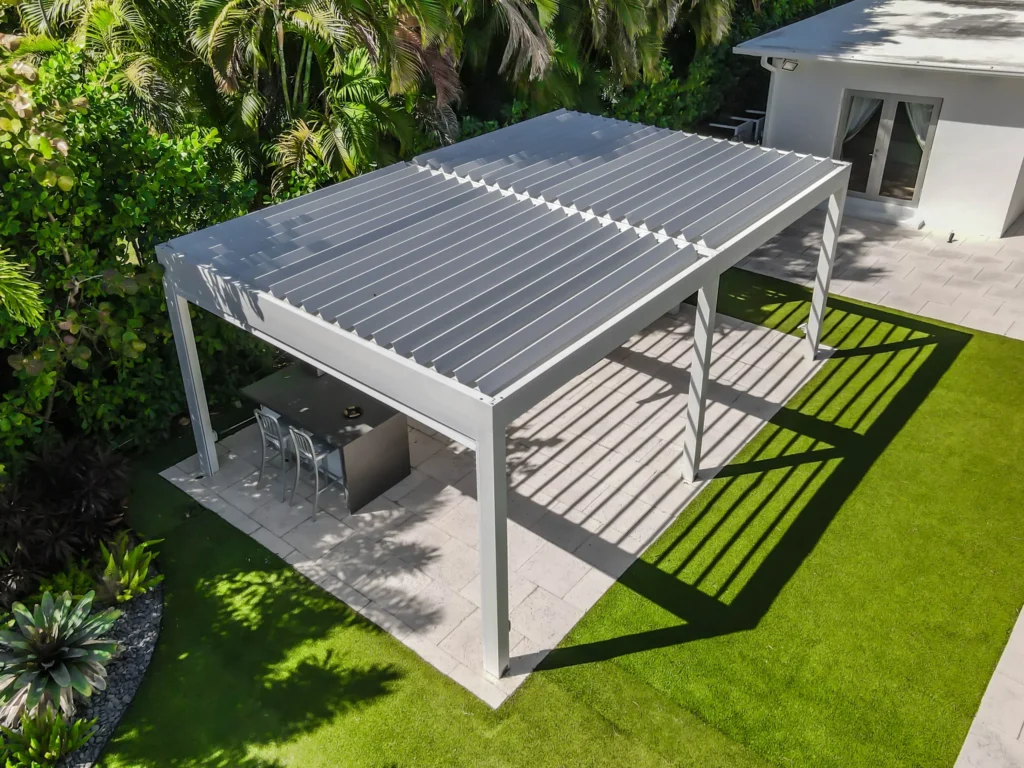 Modern aluminum pergola providing shade in a landscaped backyard.