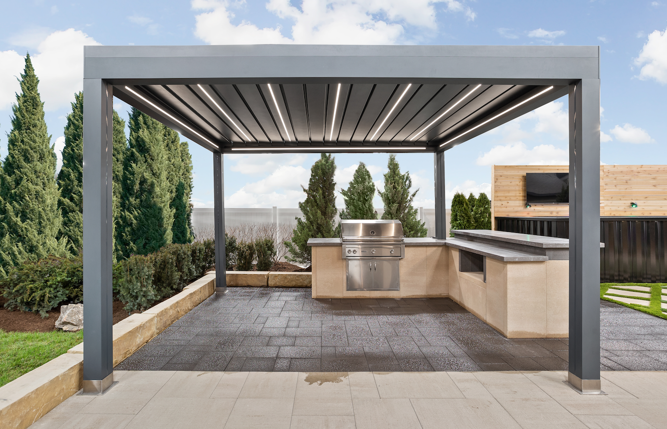 Modern outdoor pergola with adjustable louvers over kitchen area.