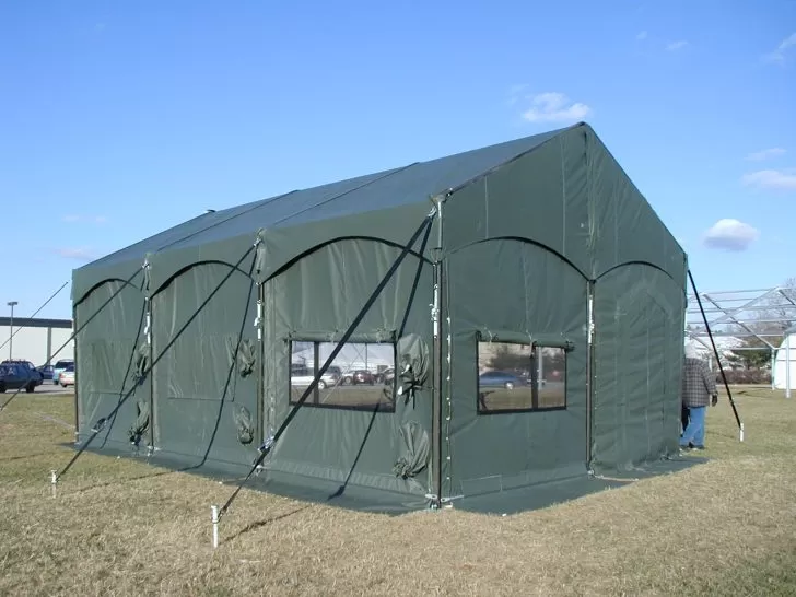 Green military shelter tent by Anchor Industries outdoor setup