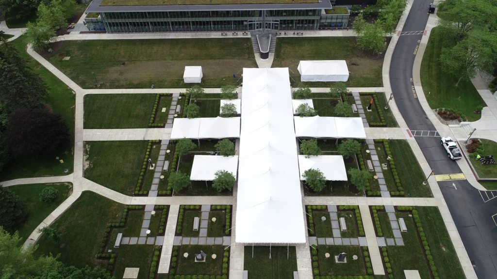 Aerial view of multiple white event tents arranged in a grid layout.