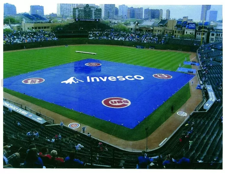 Stadium field with branded pool cover – large blue safety cover installed at sports field with sponsor logo.