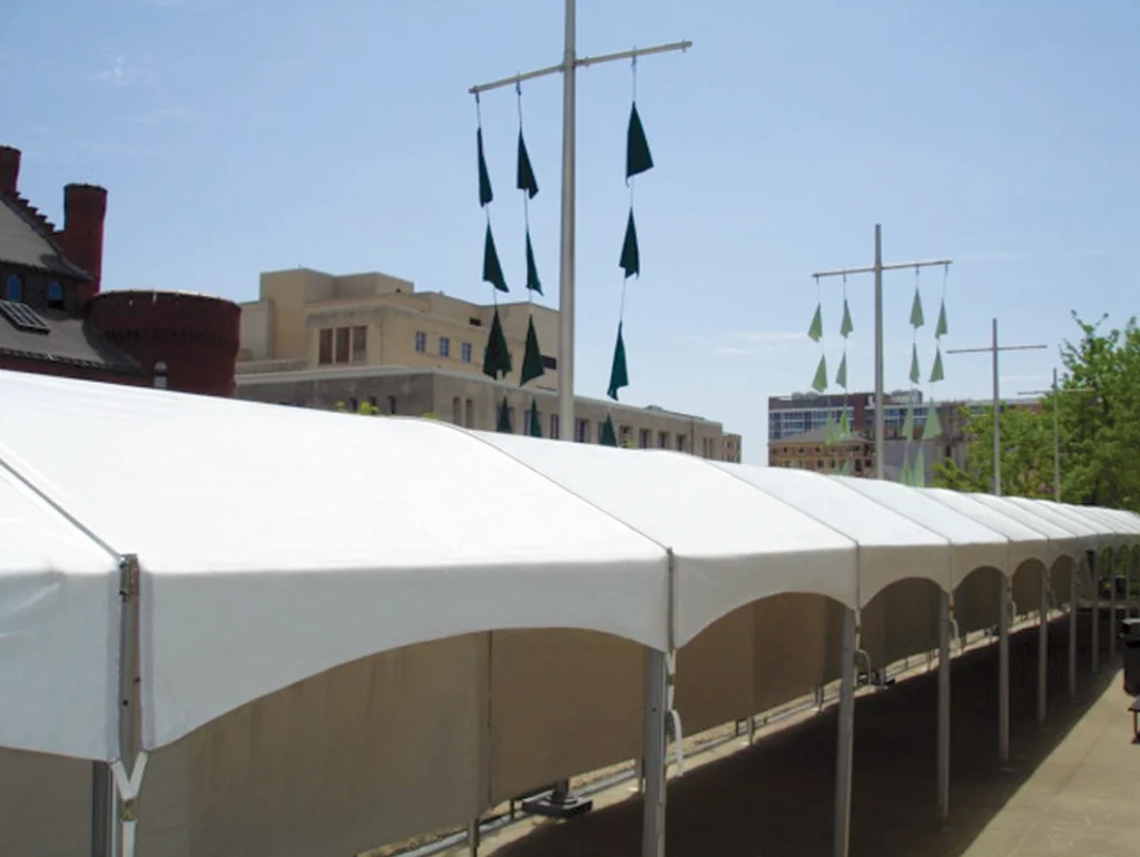 White frame tent with multiple bays installed on rooftop terrace for shade