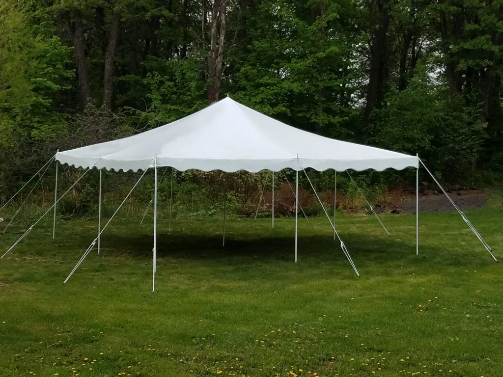 White pole tent by Anchor Industries in wooded outdoor setting