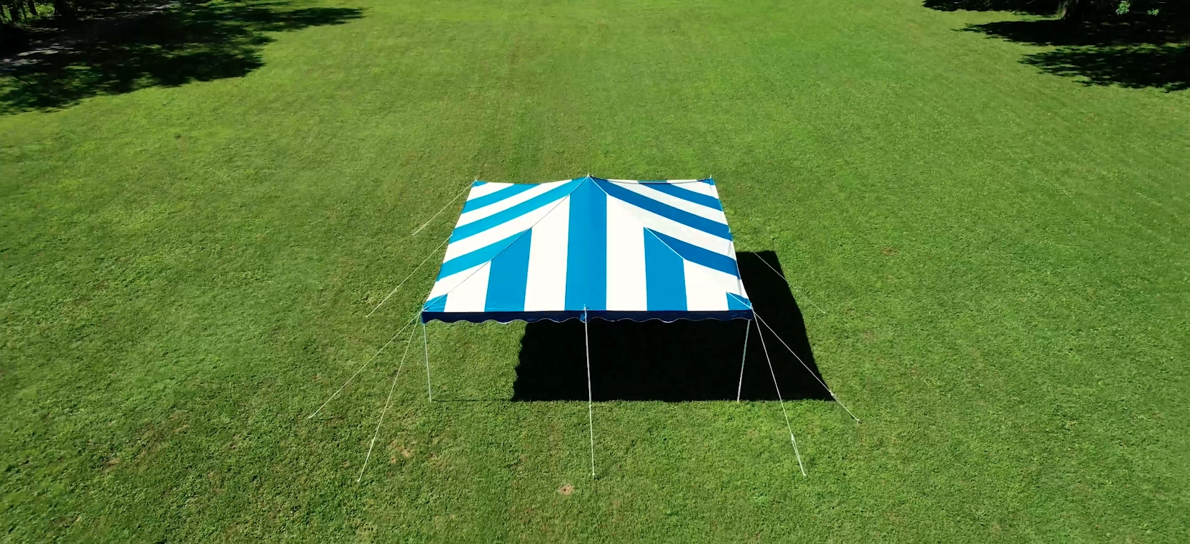 Blue and white striped Anchor Industries tent aerial view