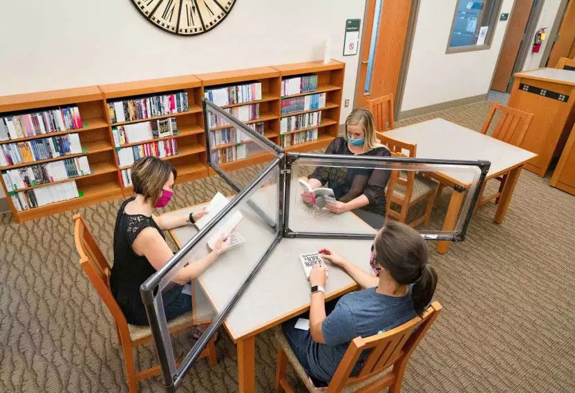 Students meeting with clear divider panel Anchor Industries